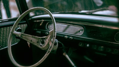 black steering wheel with brown leather strap