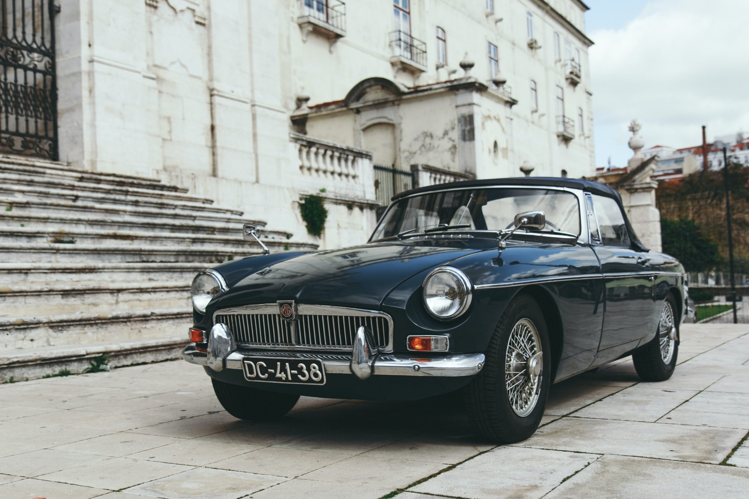 blue coupe near gray concrete staircase