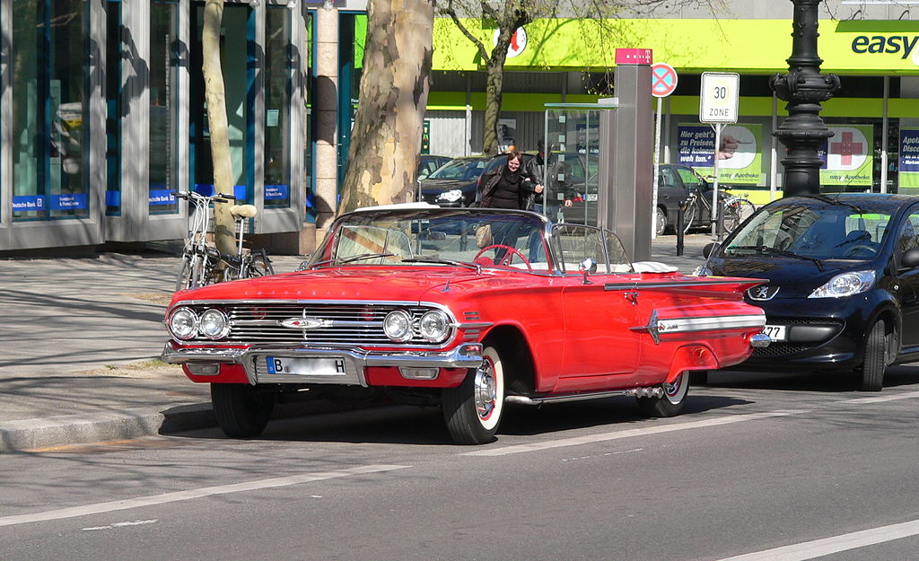 Beautiful Red and white 1960 Chevy Impala convertible with the top down