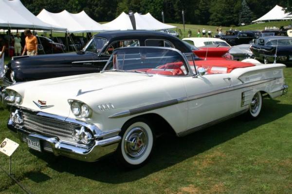 White convertible 1958 Chevy Impala convertible with a red interior