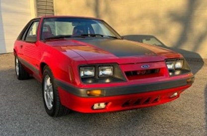 Bright red 1986 Mustang GT passenger front quarter view 