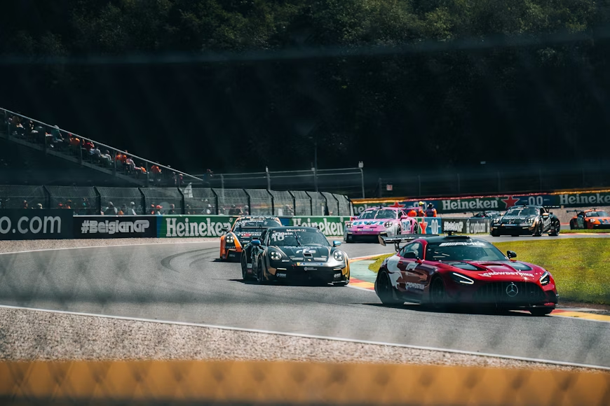 GT race cars including a Mercedes-AMG GT and Porsche 911 GT3 navigate a curve at Circuit de Spa-Francorchamps during the Belgian Grand Prix weekend